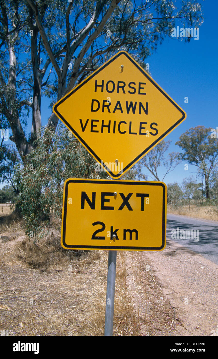 Bright yellow roadside graphics warn of horse-drawn traffic. Stock Photo