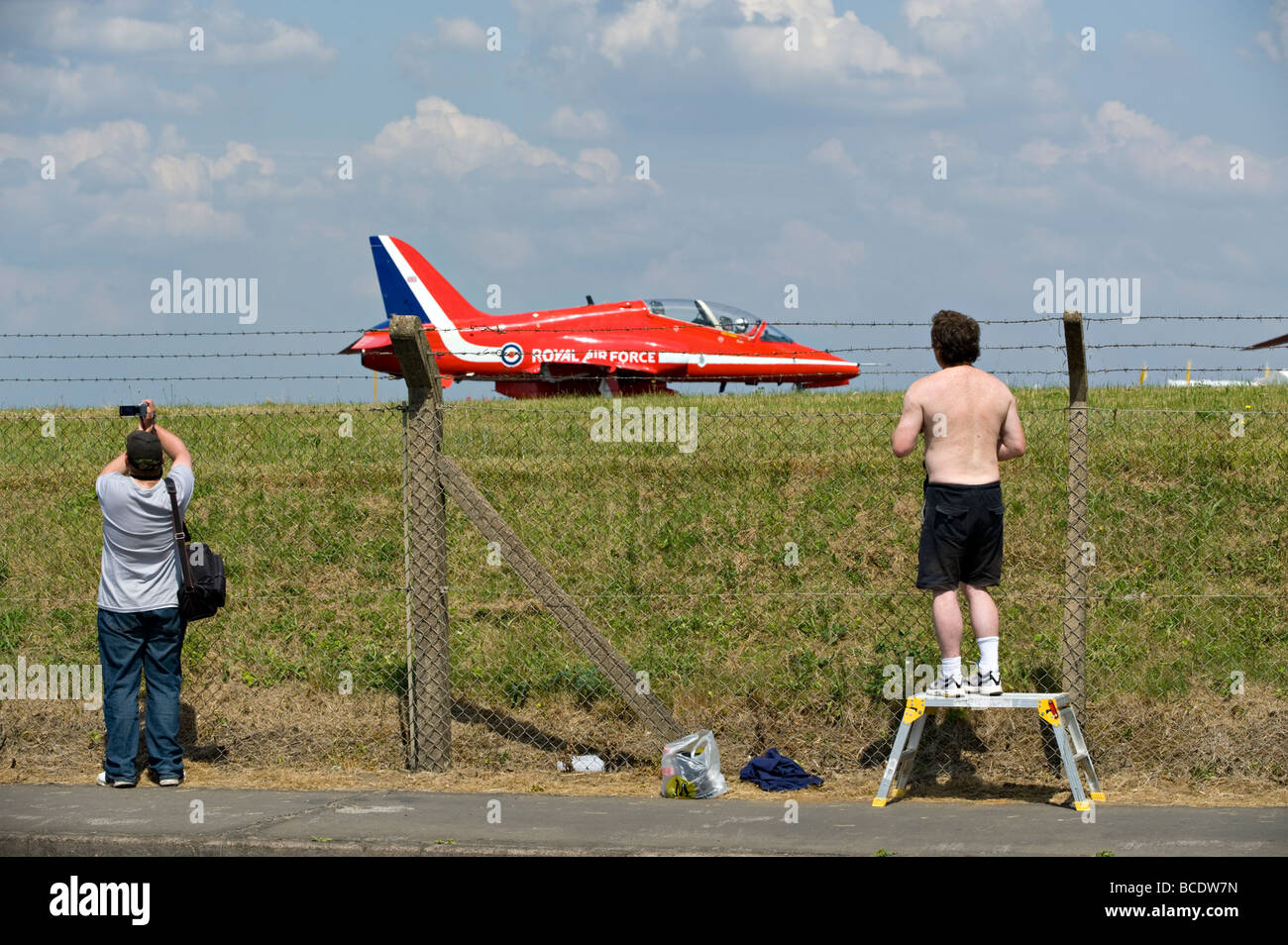 Enthusiasts watch the BAE Hawk aircraft of the RAF's aerobatic team 'The Red Arrows' at Biggin Hill, England, UK Stock Photo