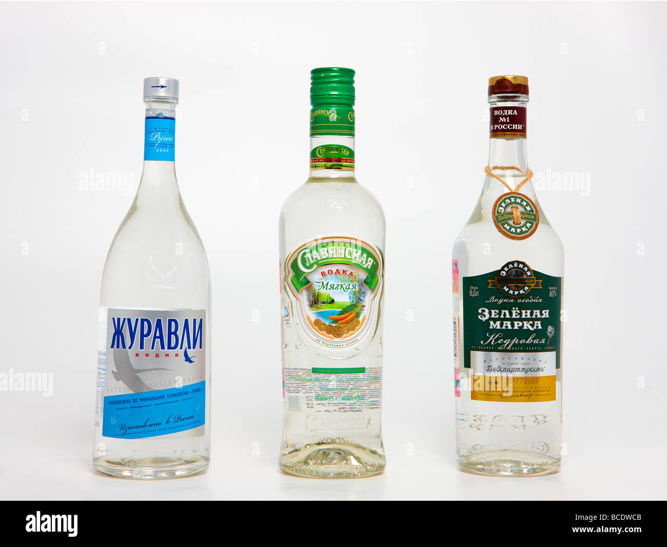 Three bottles of genuine Russian vodka against white background. Stock Photo