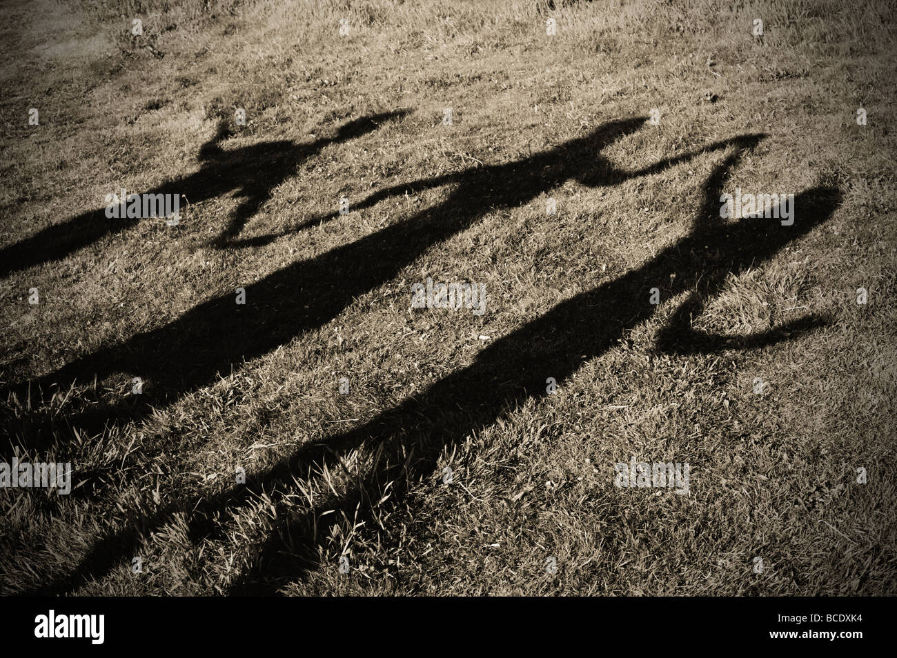 Three shadows holding hands depicting family life Stock Photo Alamy