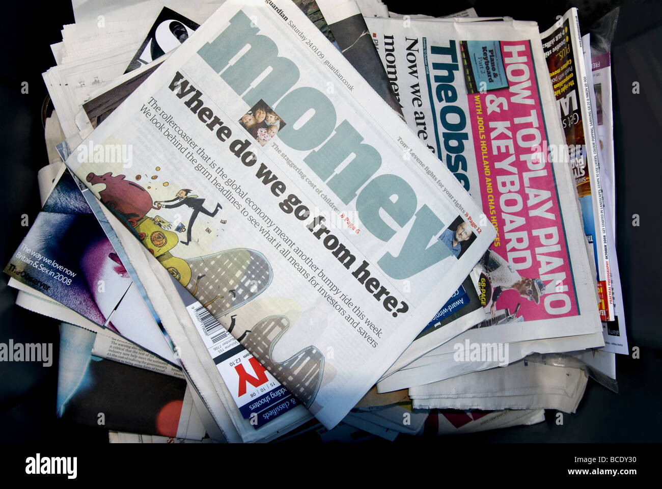 Newspapers & magazines loaded into a recycling bin Stock Photo Alamy