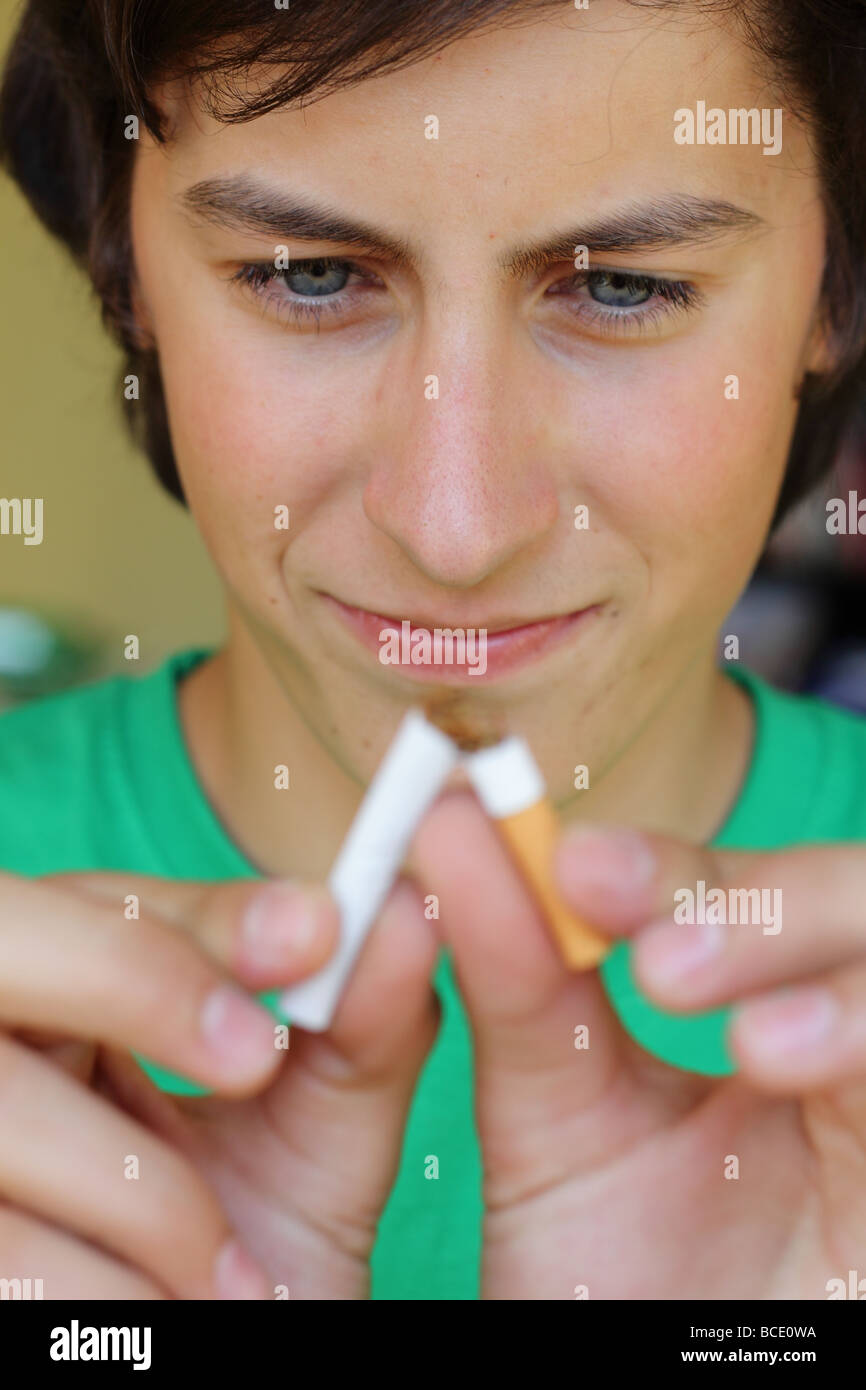 teenager breaks a cigarette Stock Photo