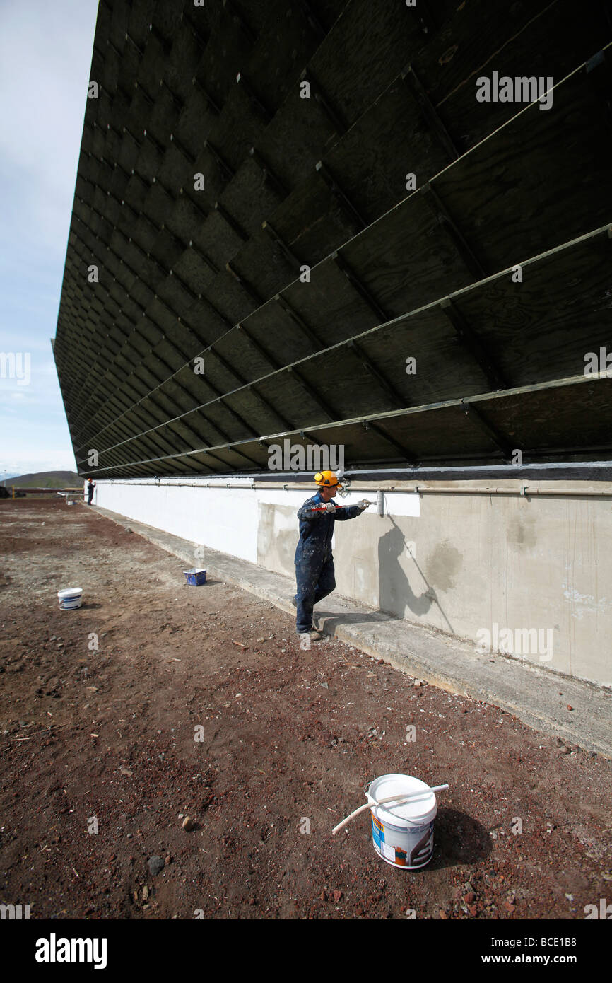 Workers paint the water cooling tower at the Krafla geothermal power