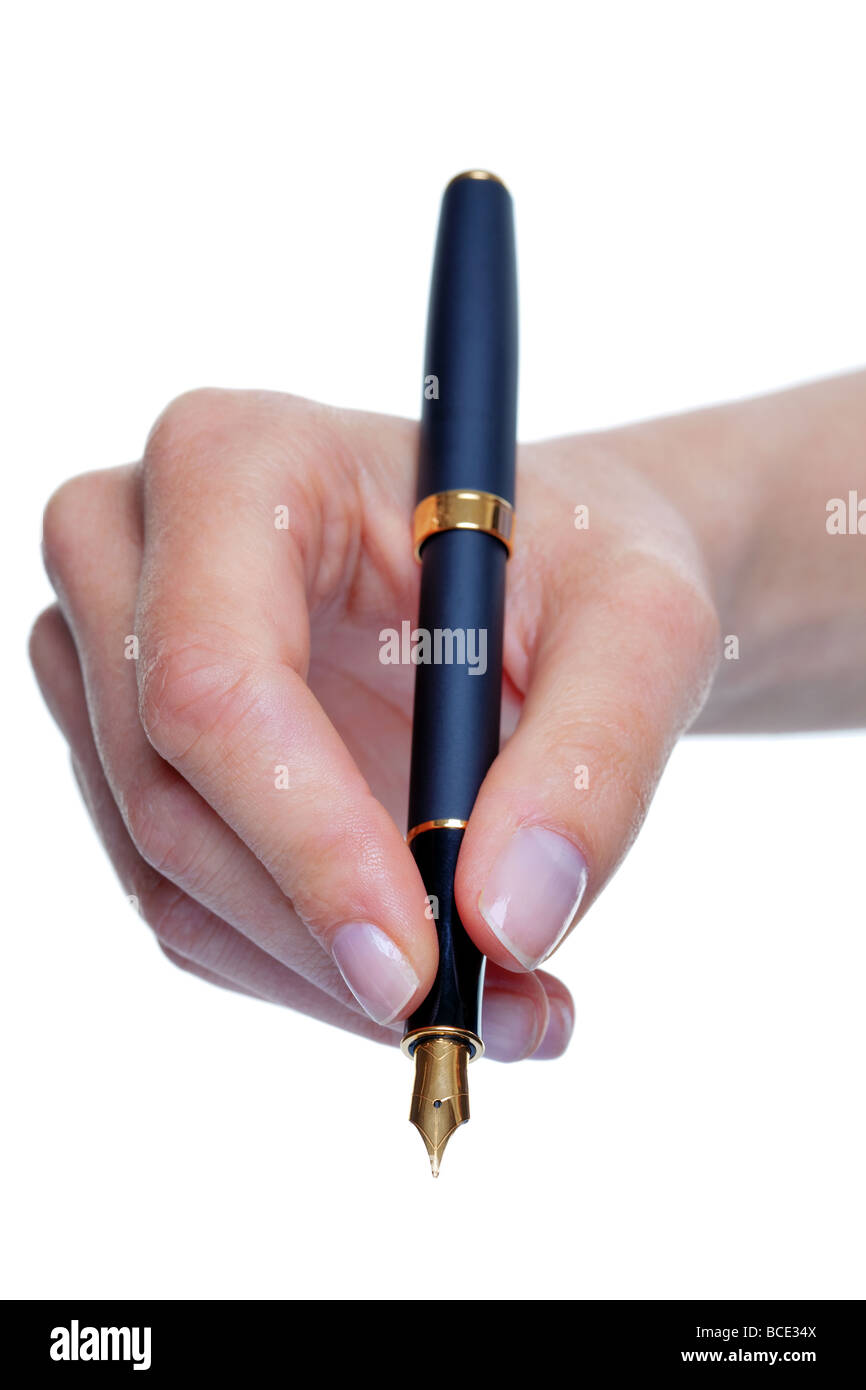 Close up of womans hand writing with a gold nib fountain pen isolated on a white background Stock Photo