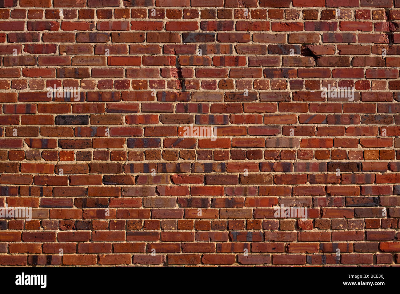 an old red brick wall with distressed character Stock Photo