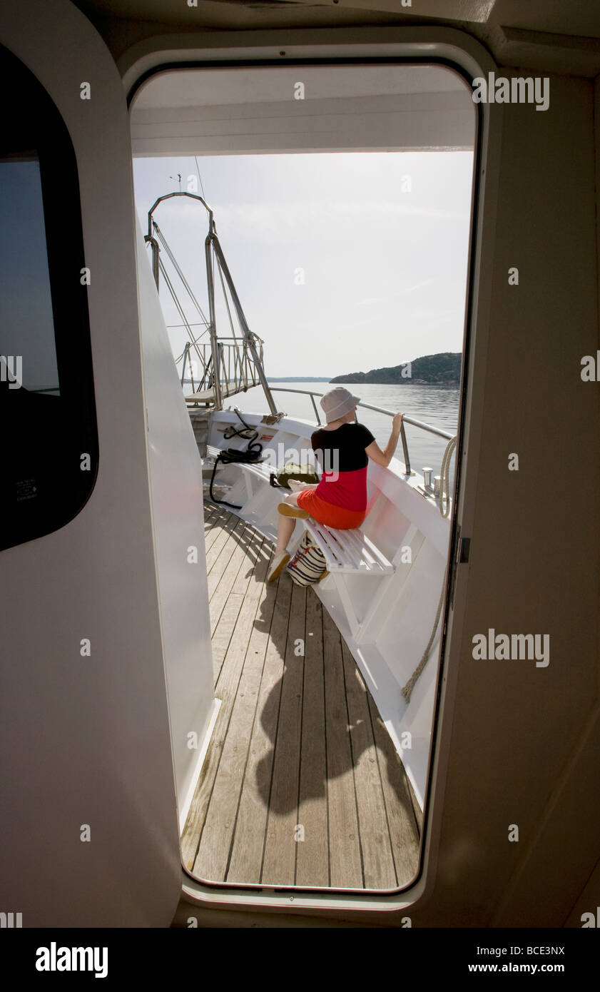 A female tourist on a boat trip in Sardinia. Stock Photo