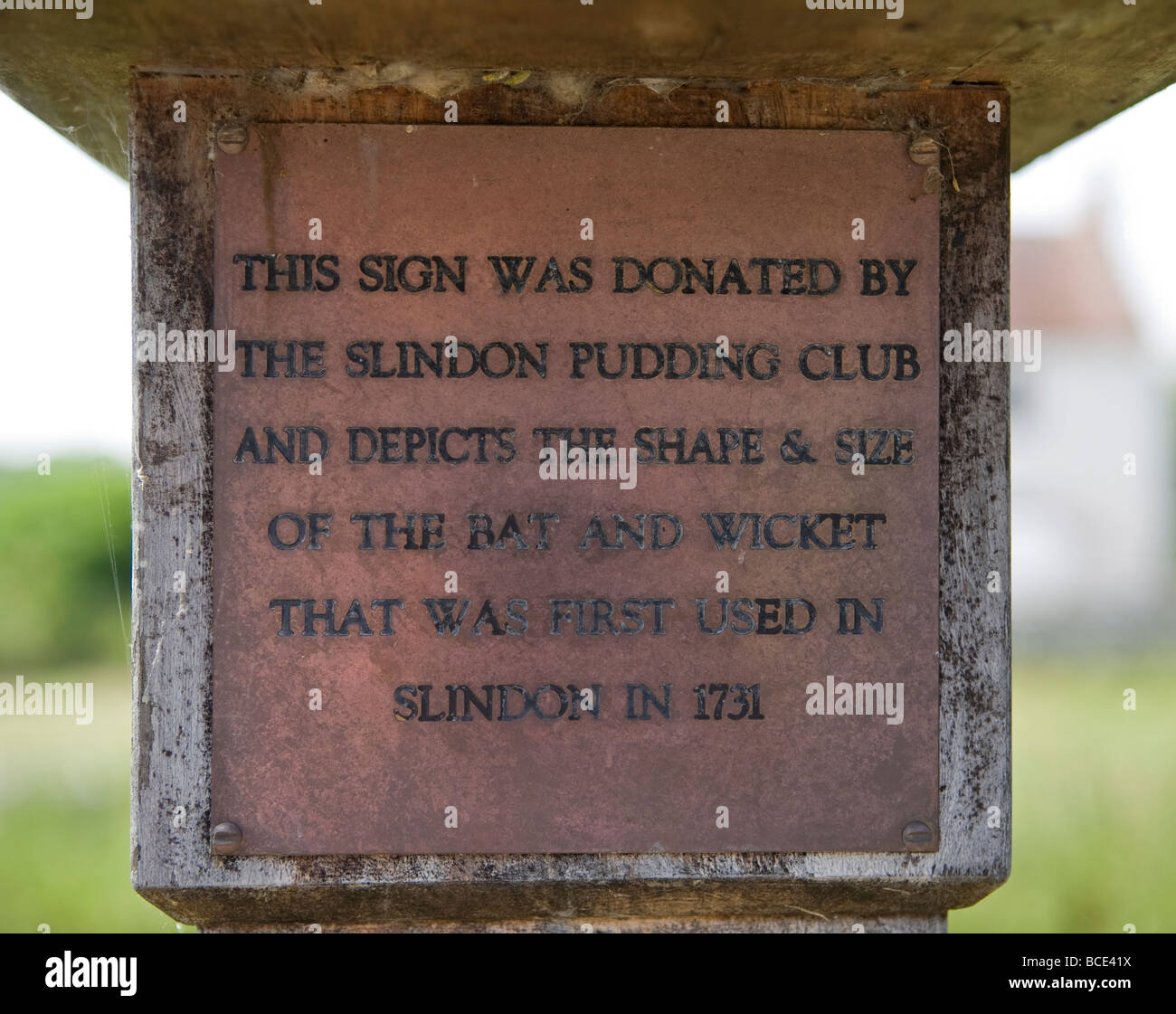 Bronze plaque on north face of Slindon Village sign with black painted incised letters, West Sussex, UK Stock Photo