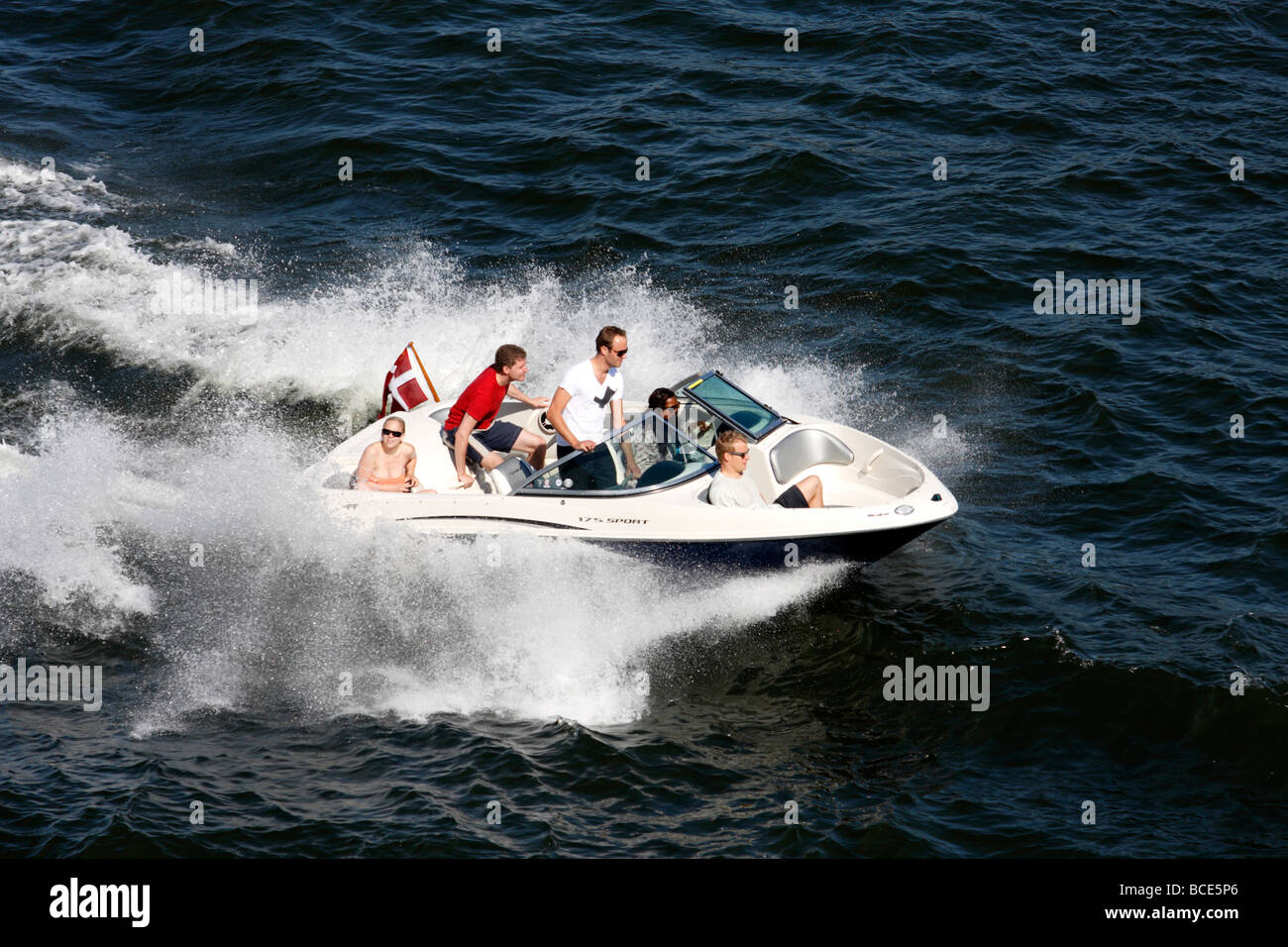 Swedish family on Recreational Boat near Stockholm with Swedish Flag Stock Photo