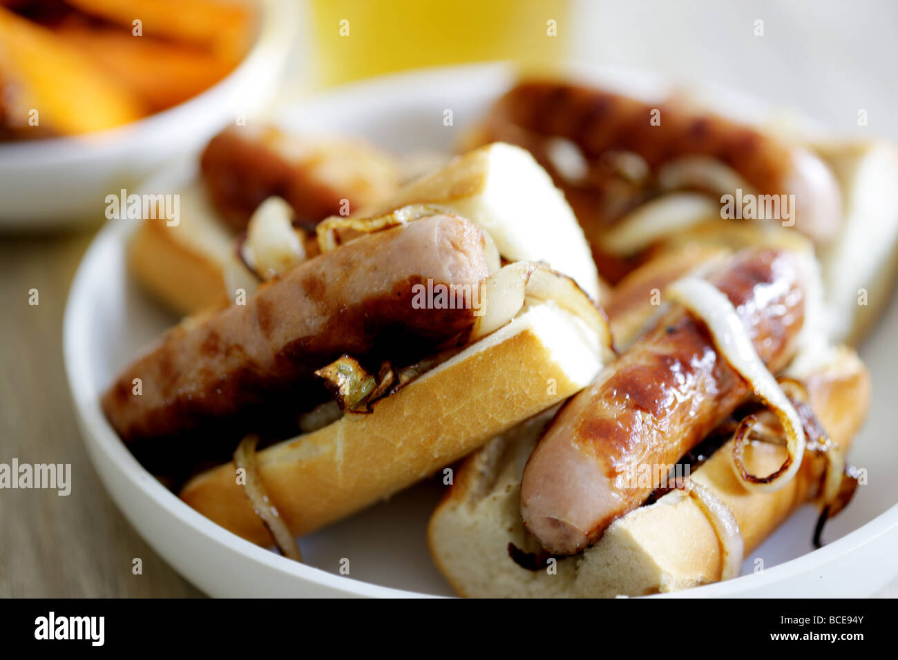 Freshly Cooked Pork Sausage Hot Dogs With Onions In A White Bread Crusty Roll Served In A Dish With No People Stock Photo Alamy