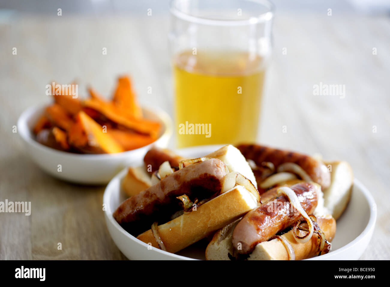 Freshly Cooked Pork Sausage Hot Dogs With Onions In A White Bread