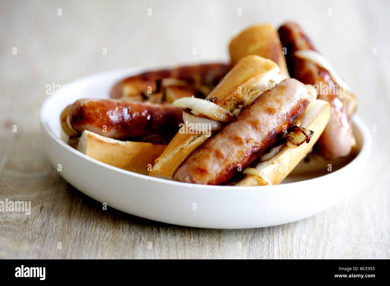 Freshly Cooked Pork Sausage Hot Dogs With Onions In A White Bread