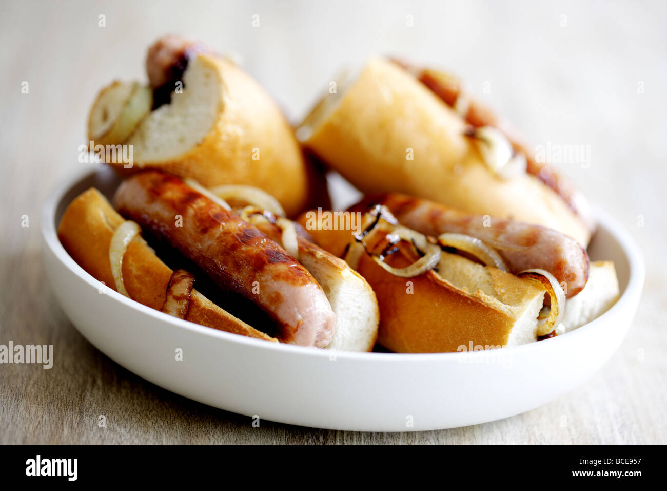 Freshly Cooked Pork Sausage Hot Dogs With Onions In A White Bread