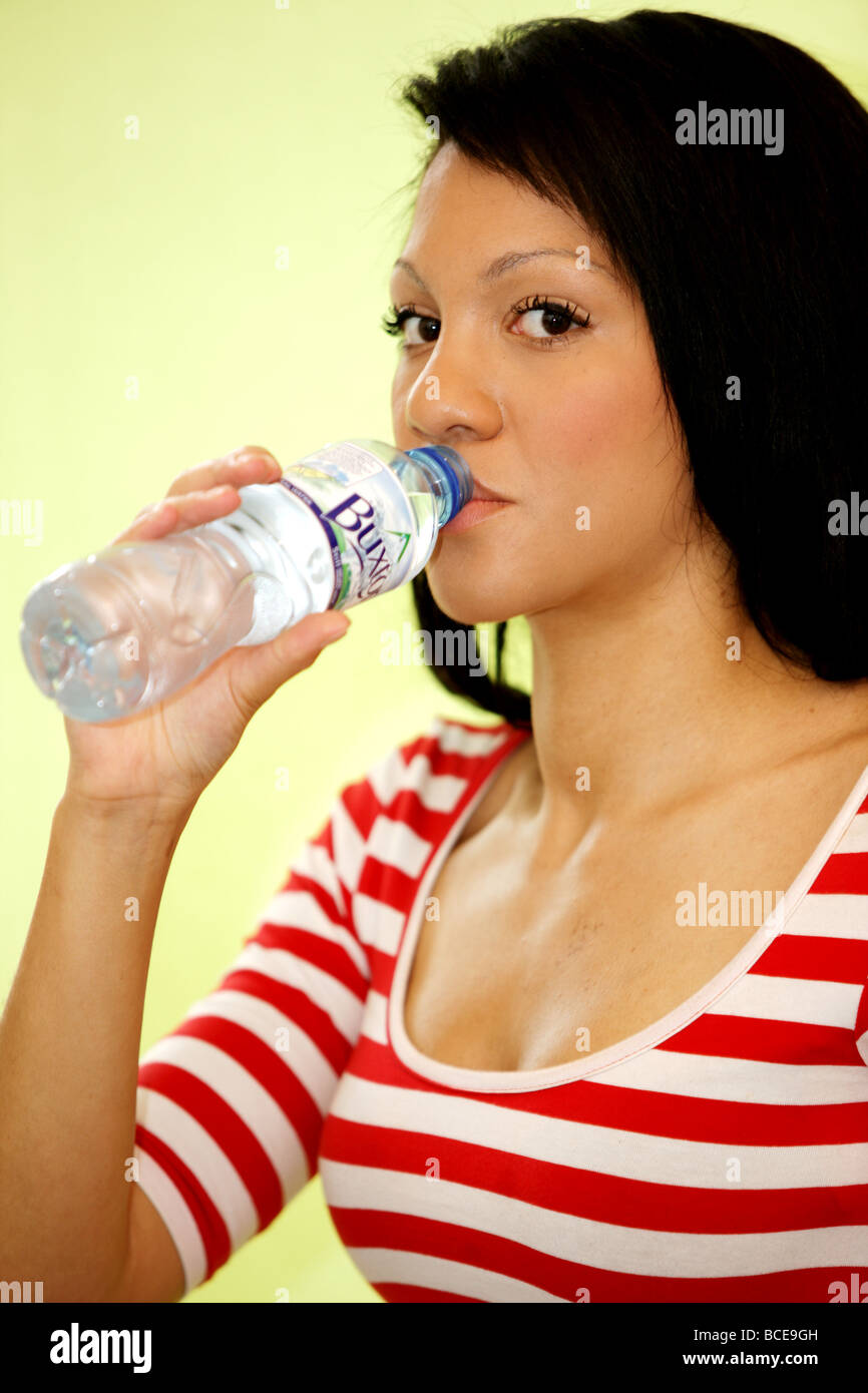 Healthy Young Woman Drinking Mineral Water Model Released Stock Photo