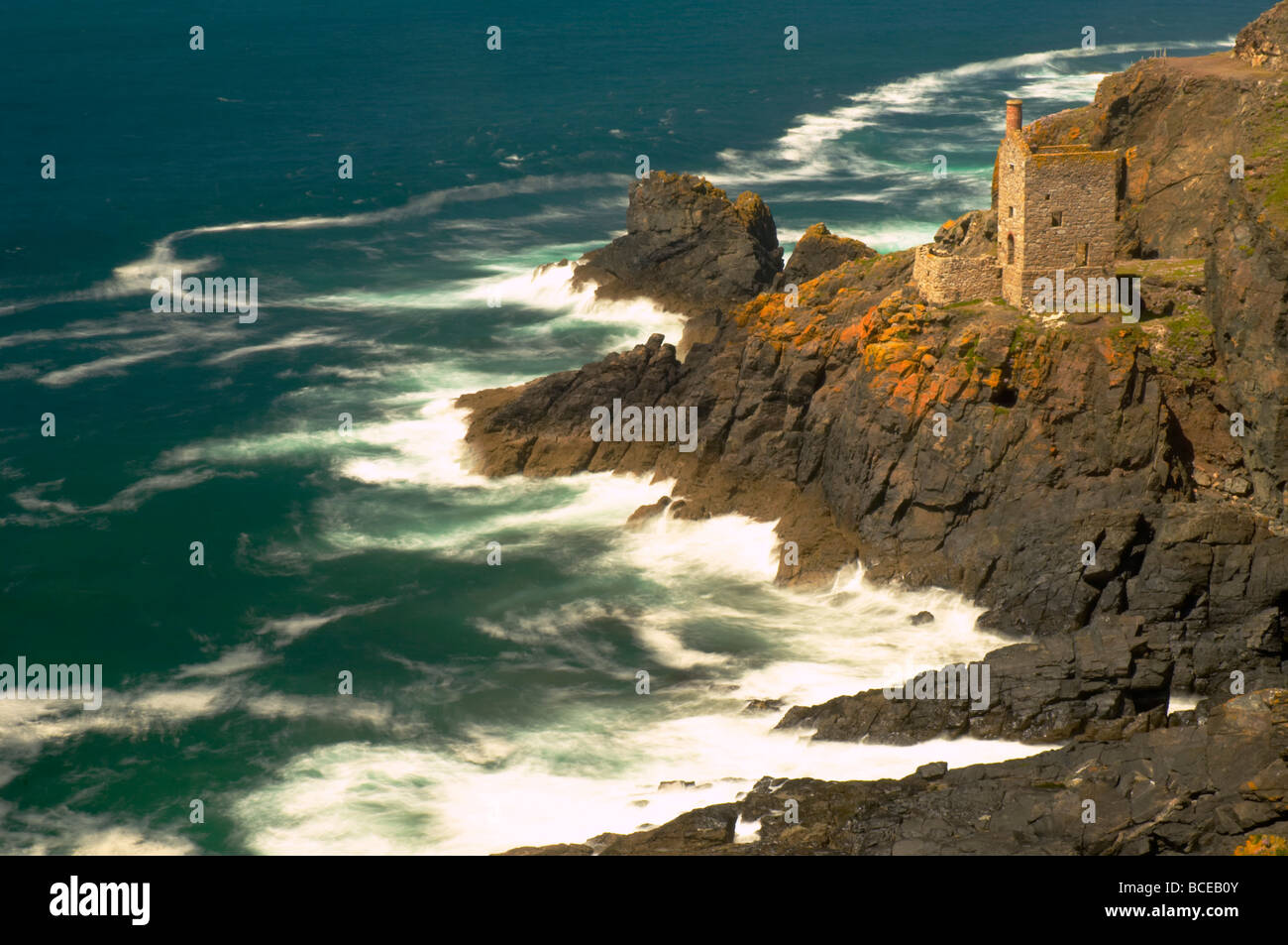 Rough seas crashing into the rocks below the old ruins of Crown mines at Botallack on the Cornish coast St Just UK Stock Photo