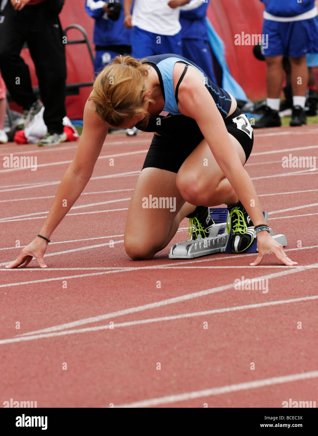 Female Athlete Waiting In The Starting Blocks For The 100m Dash Stock Photo Alamy