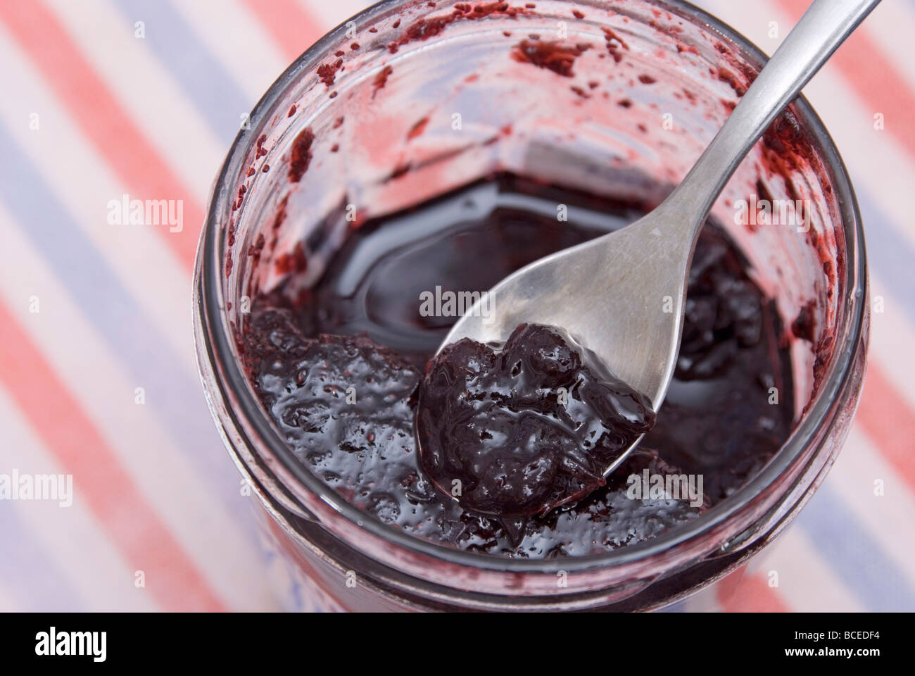 Started pot of raspberry jam Stock Photo