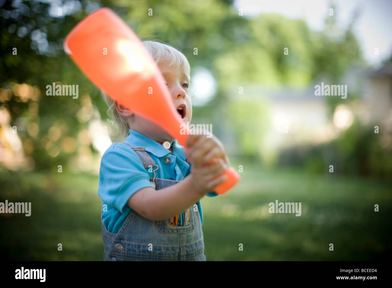 Toddler playing outdoors with a baseball bat Stock Photo Alamy