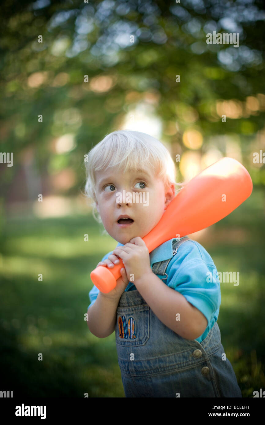 Toddler playing outdoors with a baseball bat Stock Photo Alamy