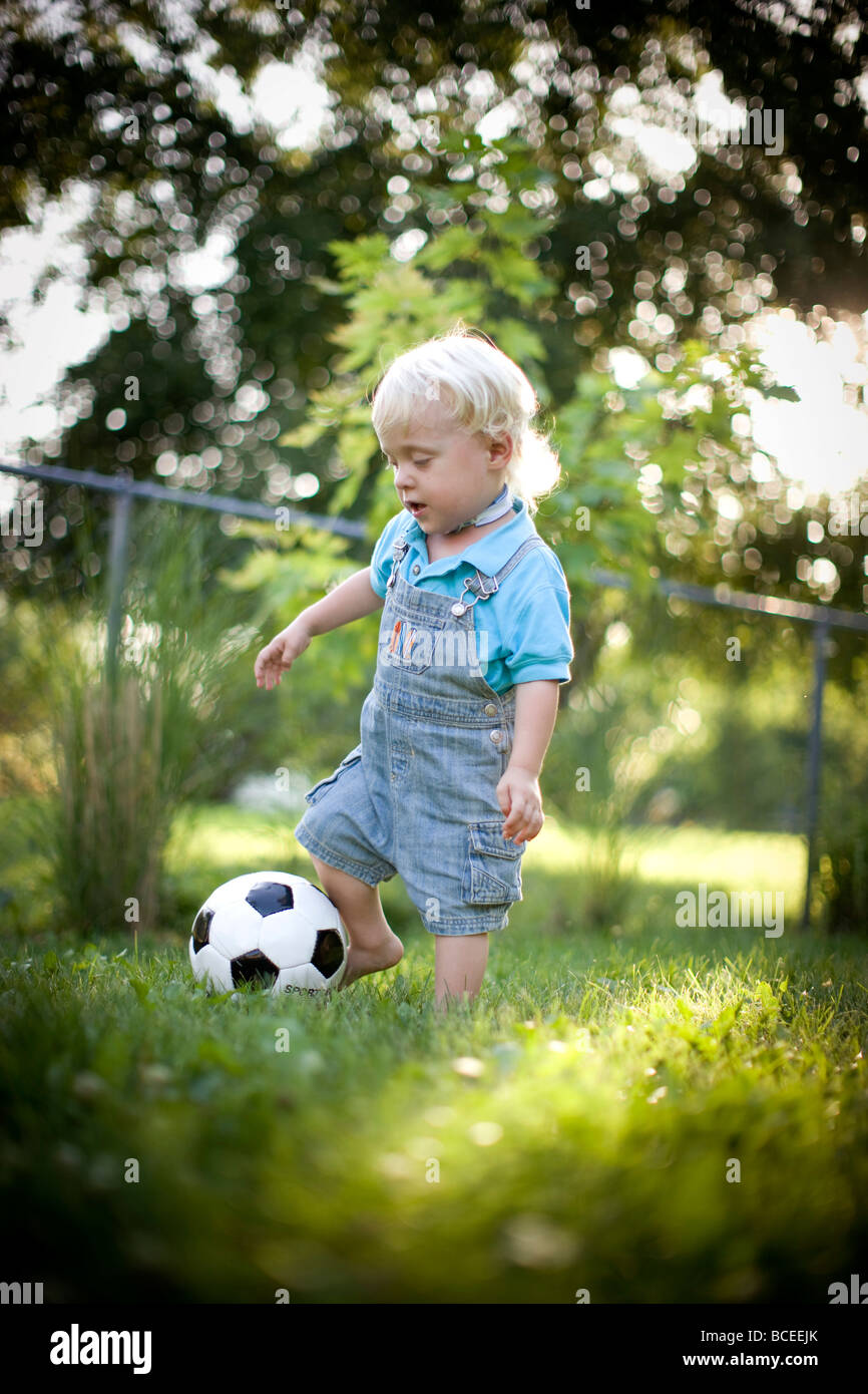 Toddler playing outdoors with a soccer ball Stock Photo Alamy