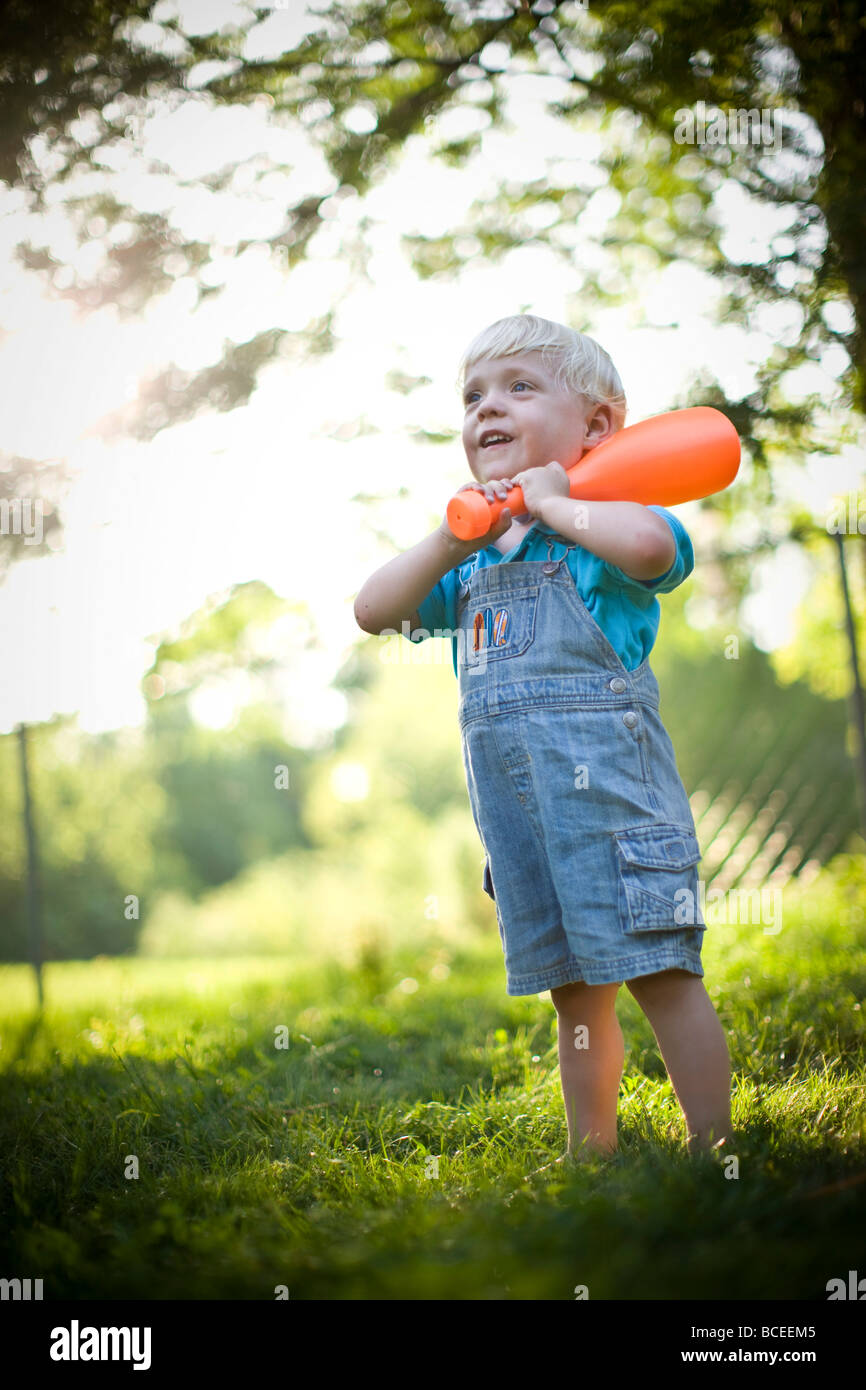 Toddler playing outdoors with a baseball bat Stock Photo Alamy