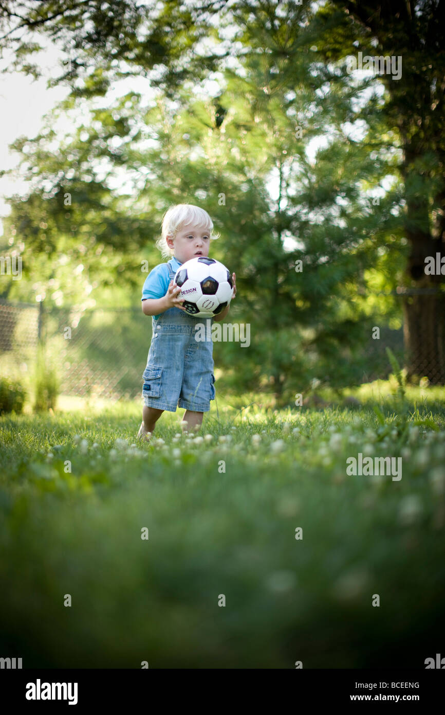 Toddler playing outdoors with a soccer ball Stock Photo Alamy