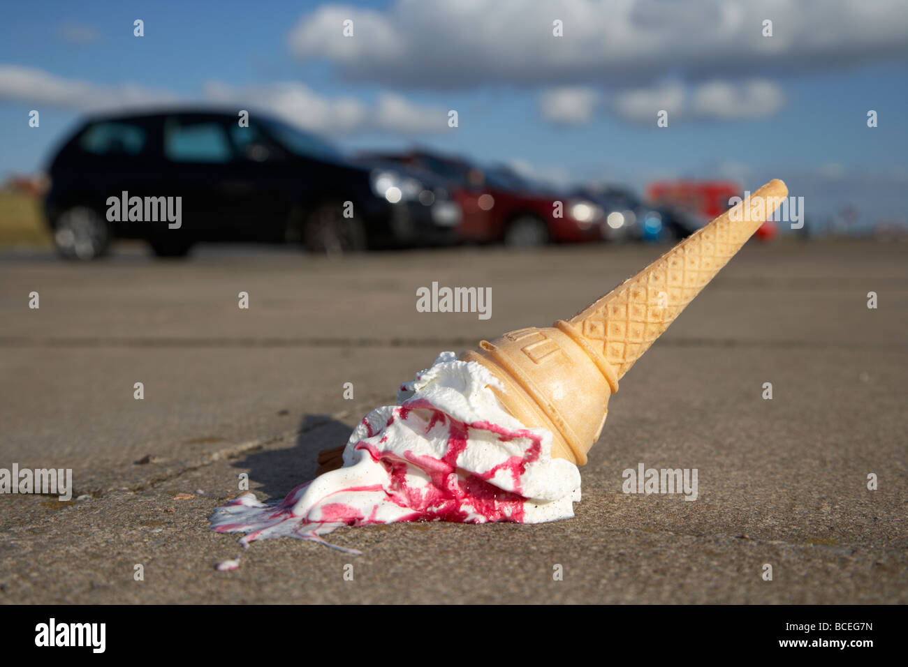ice cream cone dropped onto pavement in a car park Stock Photo Alamy