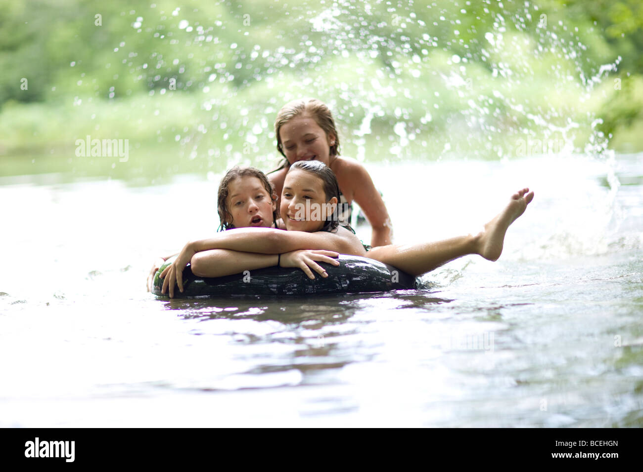 Teenagers floating on an innertube Stock Photo