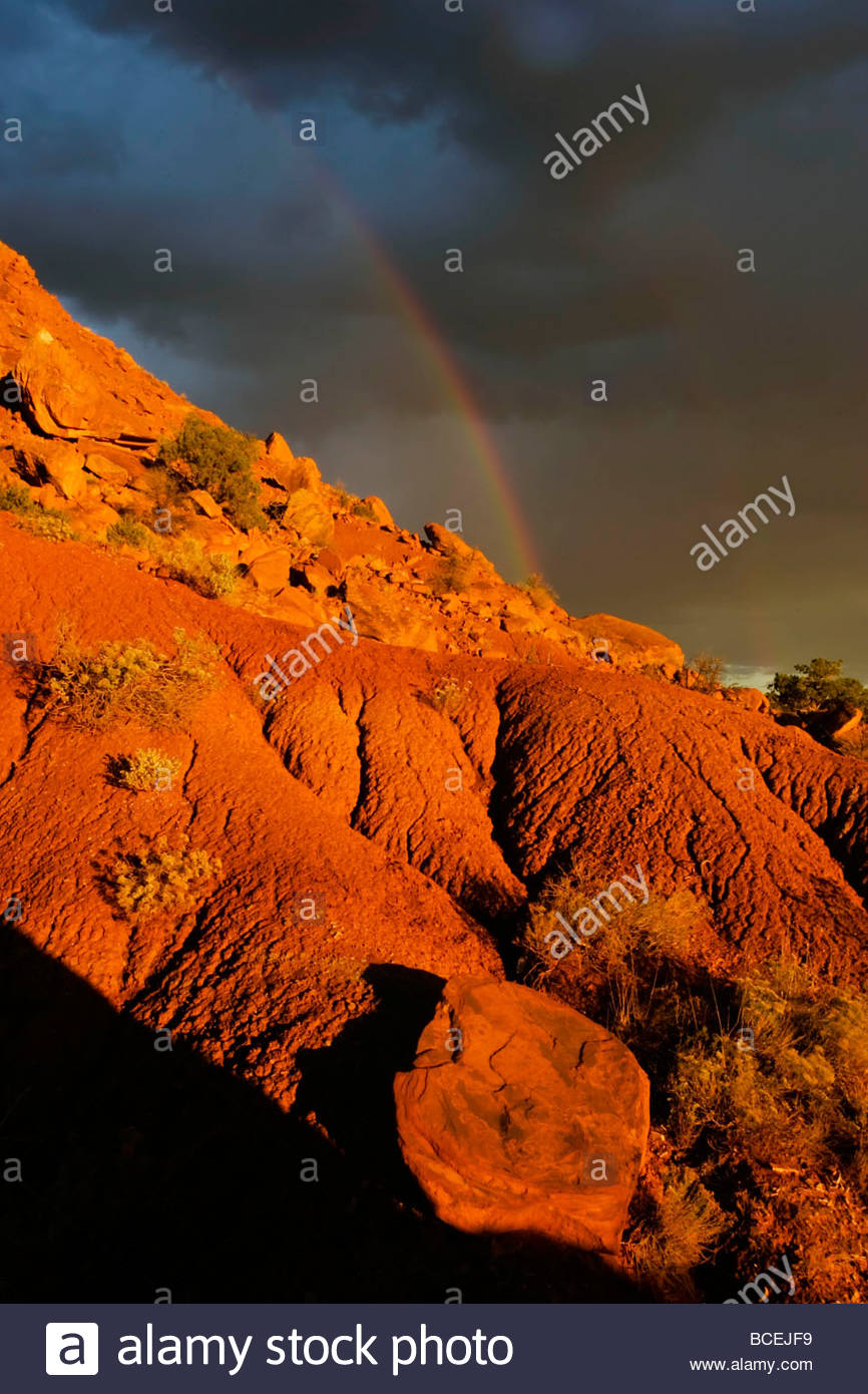 A rainbow in the sky behind red rocks in Georgia O'Keeffe country Stock ...