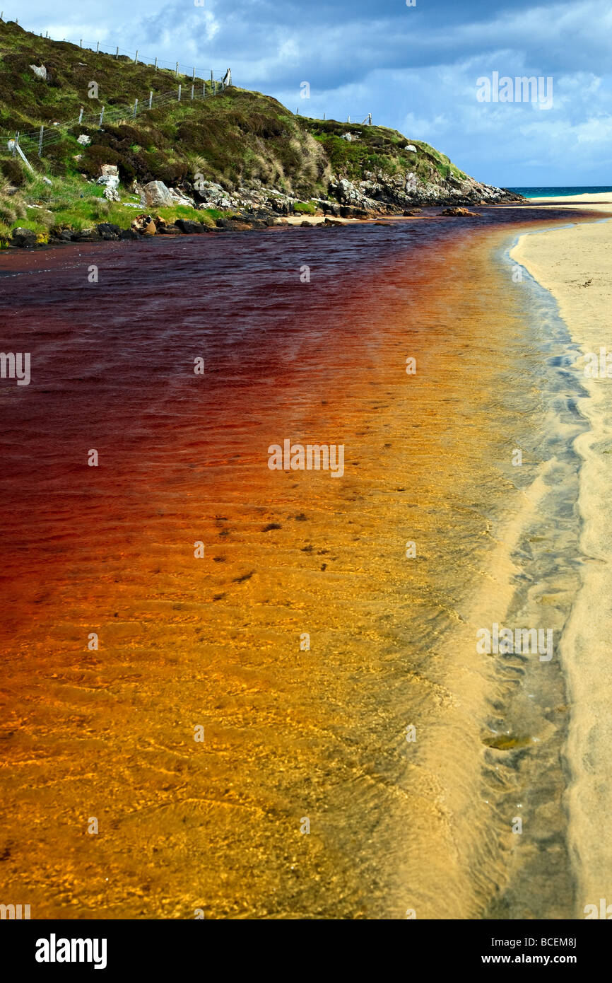 A red peat stream on Traigh Mhor beach Isle of Lewis, Outer Hebrides, Western Isles, Scotland UK 2009 Stock Photo