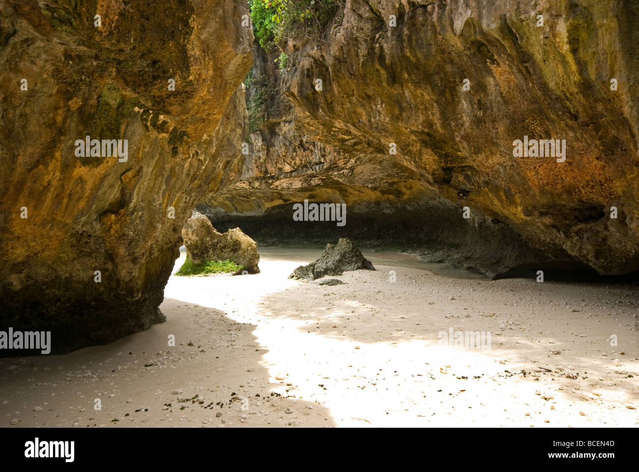 The famed cave at Uluwatu is the only way in or out of the surf mecca. Stock Photo