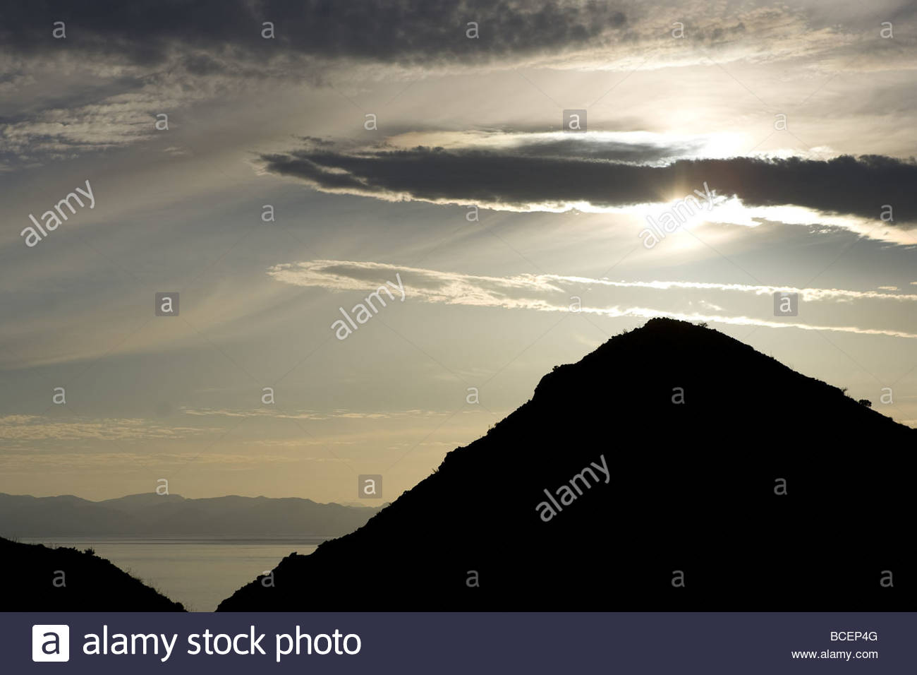 The sun shines through a patch of clouds Stock Photo - Alamy