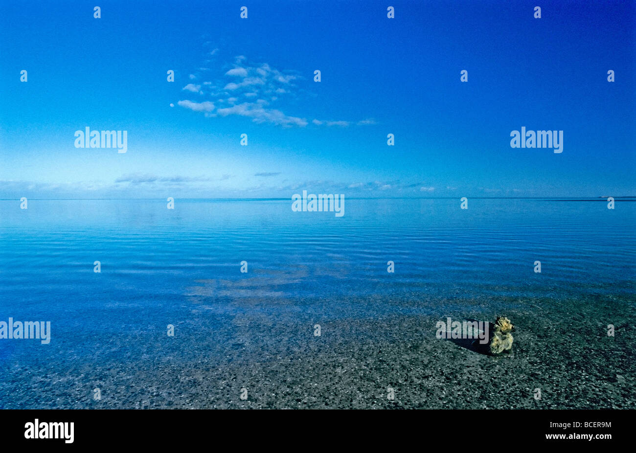 Clear blue skies settle over the mirror calm seas of L'Haridon Bight. Stock Photo
