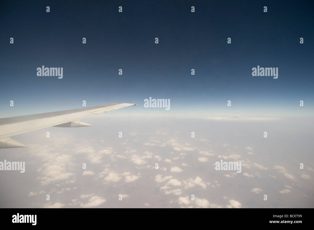 plane wing over african clouds Stock Photo