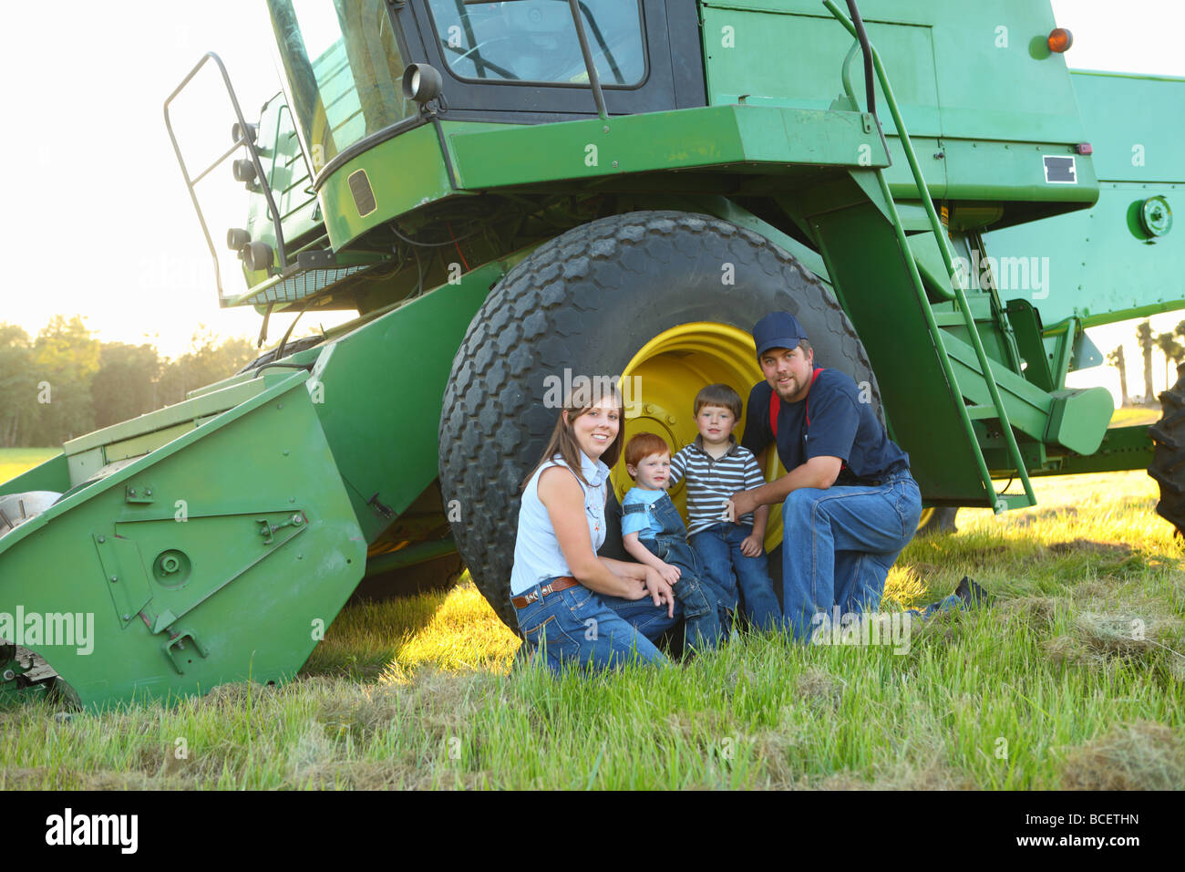 Farm family portrait by combine Stock Photo