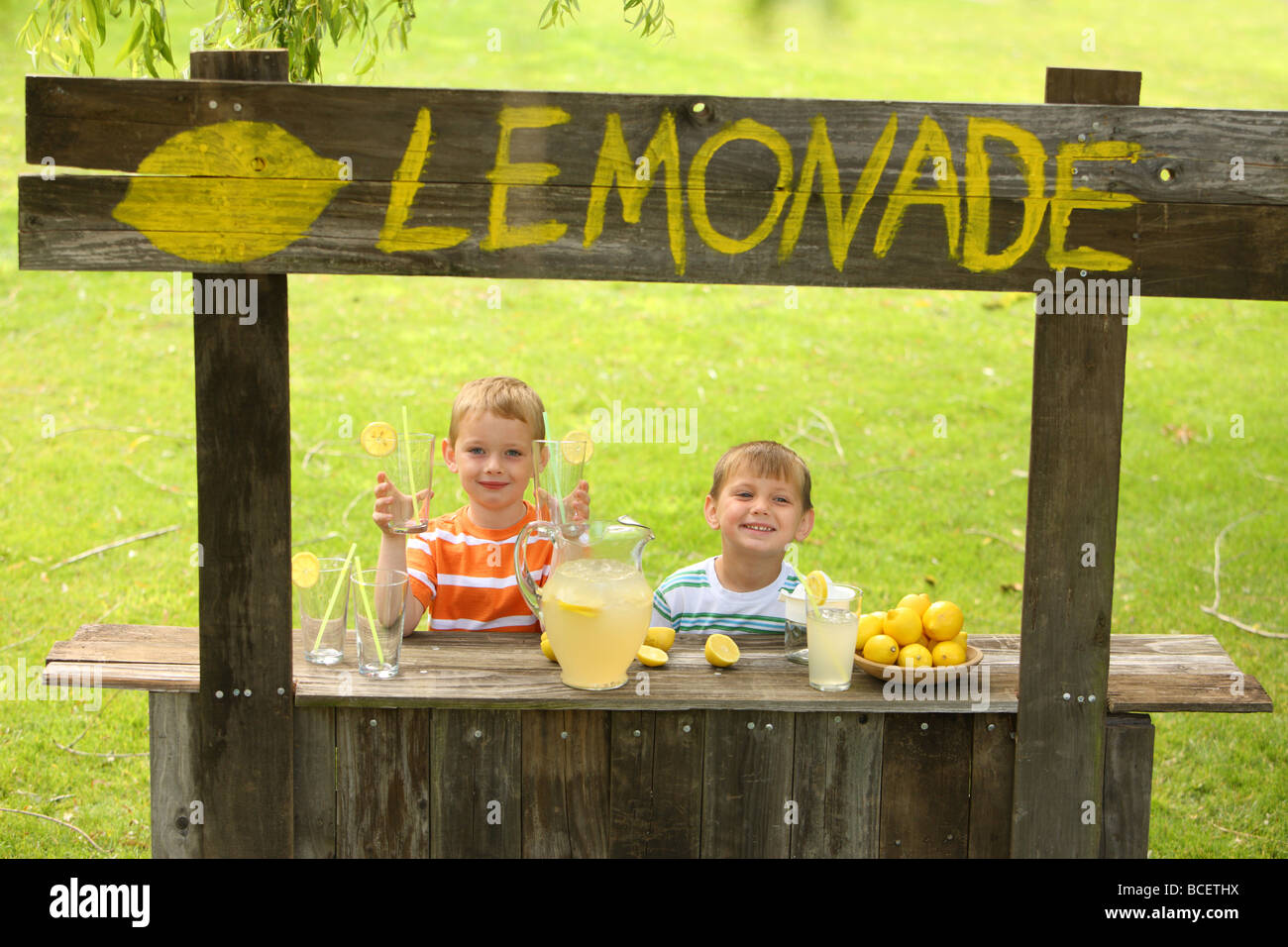 Two young boys at lemonade stand Stock Photo