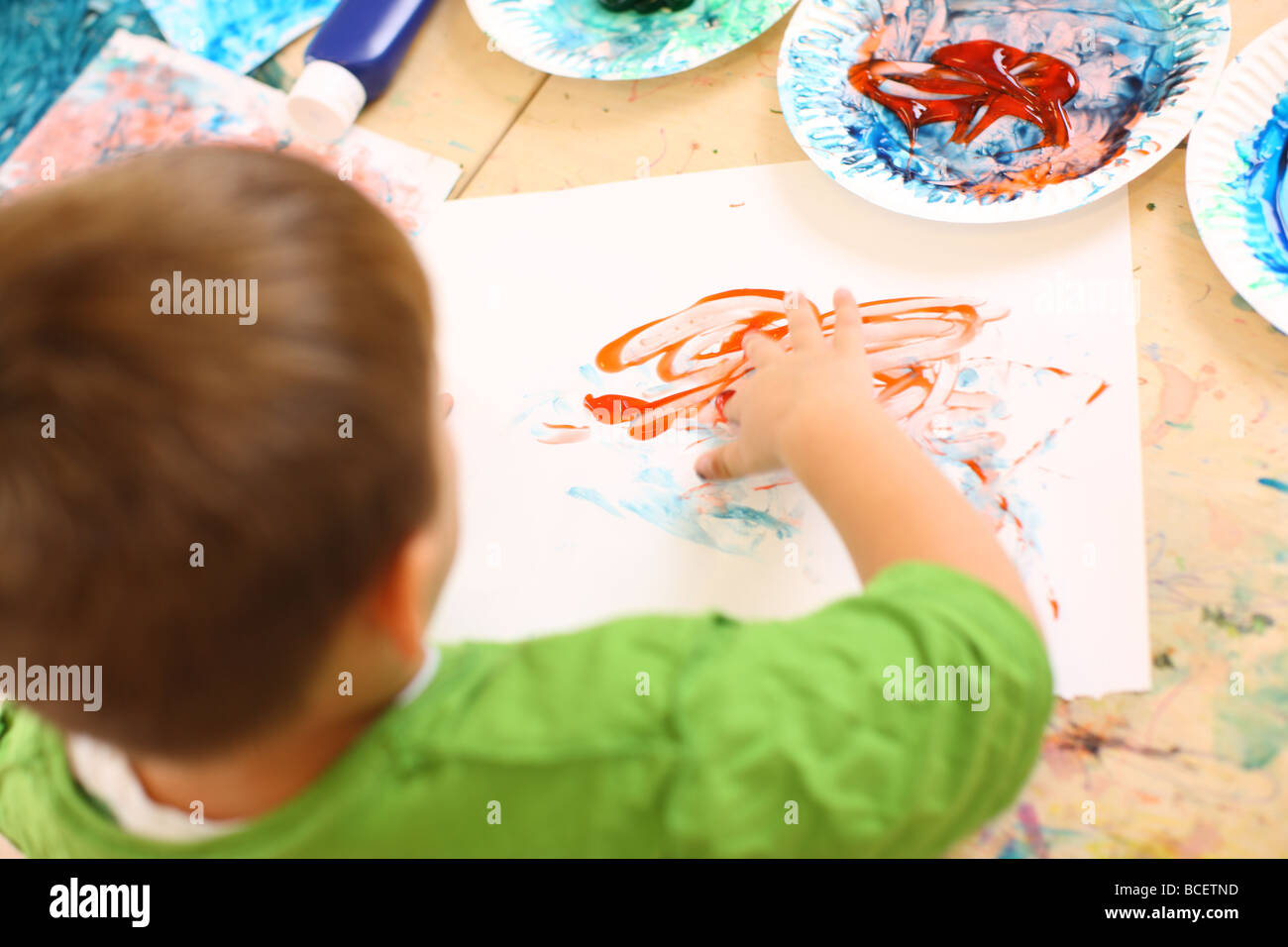 Preschool kid finger painting Stock Photo