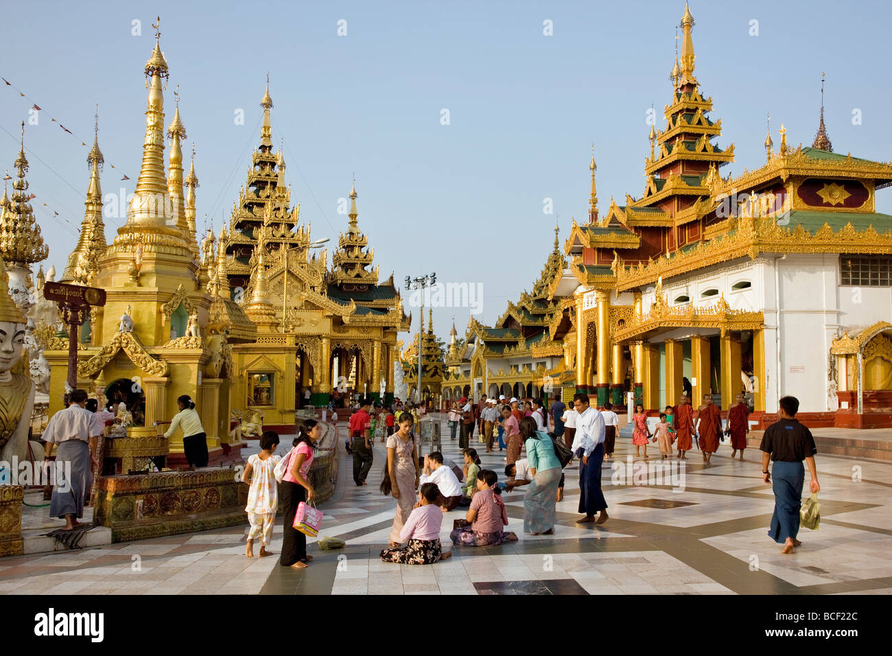 Myanmar, Burma, Yangon. Buddhists pray at the small stupas, temples, shrines, prayer halls, pavilions. Stock Photo