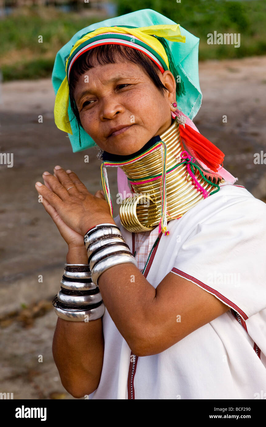 Myanmar, Burma, Lake Inle. A Padaung woman demonstrates how she sleeps in her brass necklace by unclipping the lower part. Stock Photo