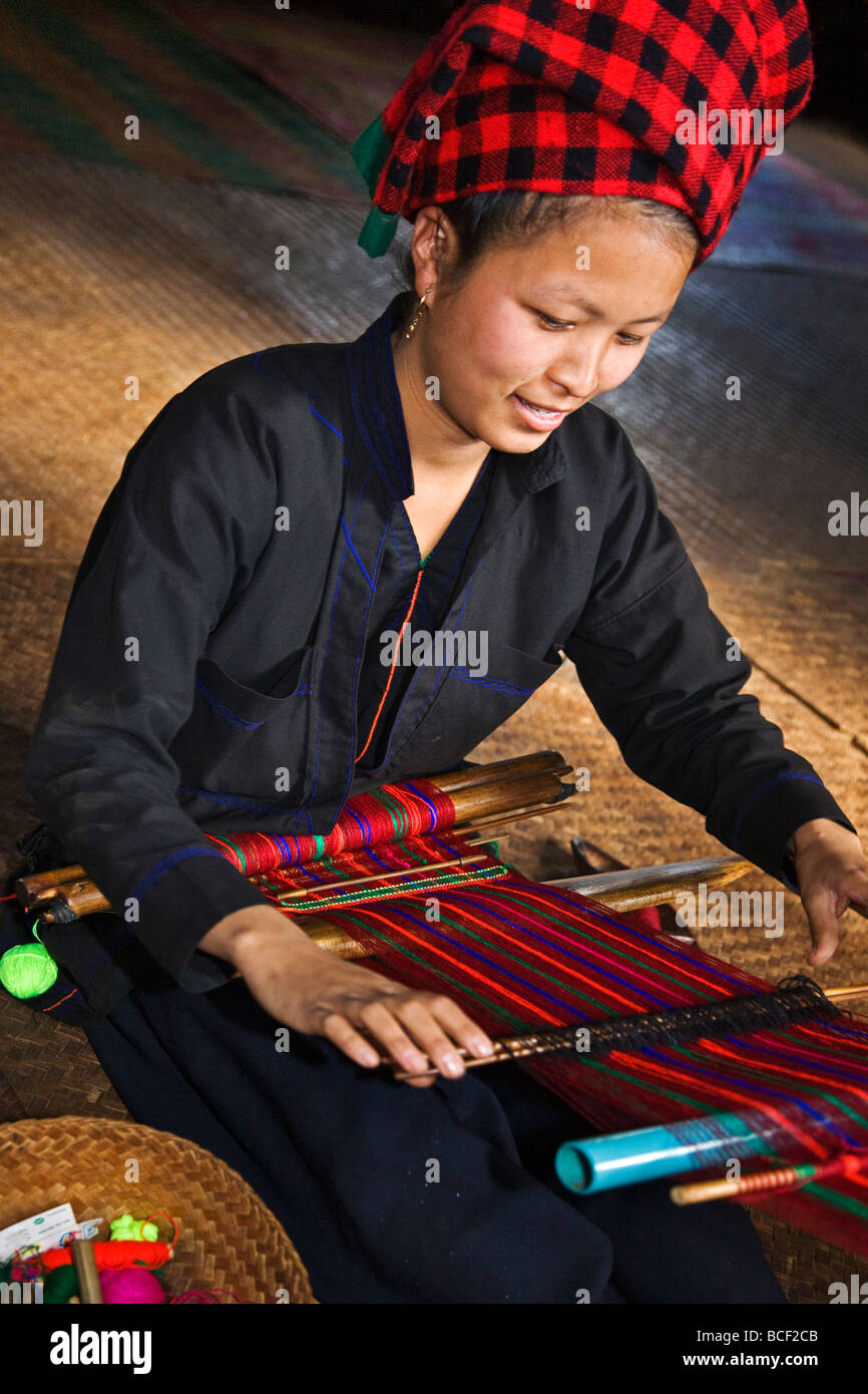 Myanmar, Burma, Lake Inle. A pretty Pa-O woman weaves brightly coloured material at Kya-Toon village. Stock Photo