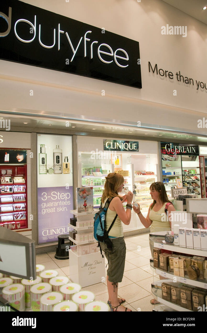 Two girls buying Duty Free perfume, Departure Lounge, North terminal Gatwick airport, UK Stock Photo