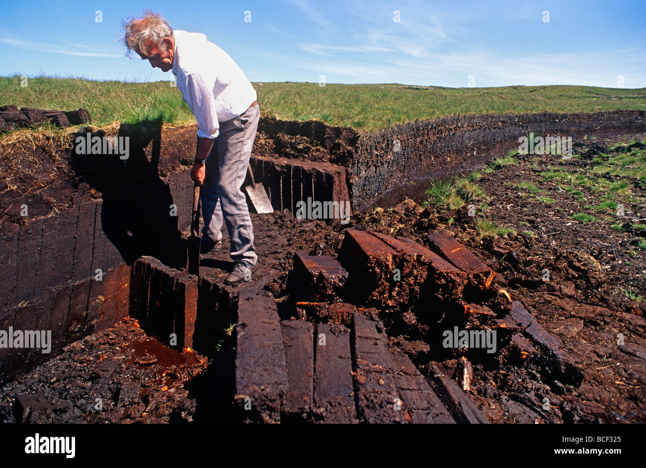 Northern Ireland, Co. Antrim. Hand cutting peat bog turf, Ballycastle