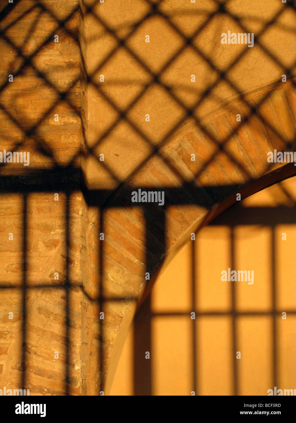 metal bars grill shadow detail on church wall in rome italy Stock Photo