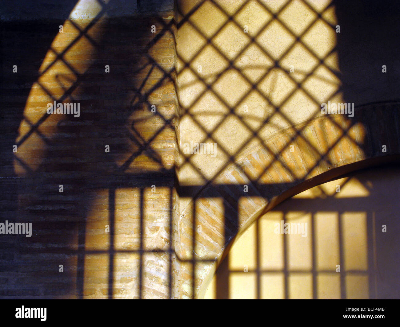 metal bars grill shadow detail on church wall in rome italy Stock Photo