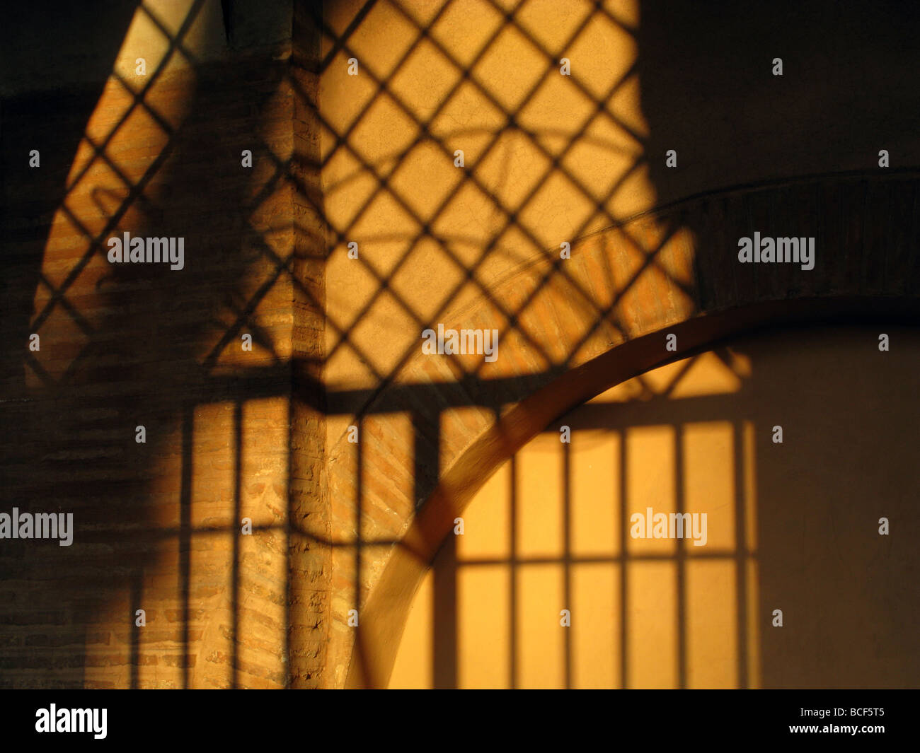 metal bars grill shadow detail on church wall in rome italy Stock Photo