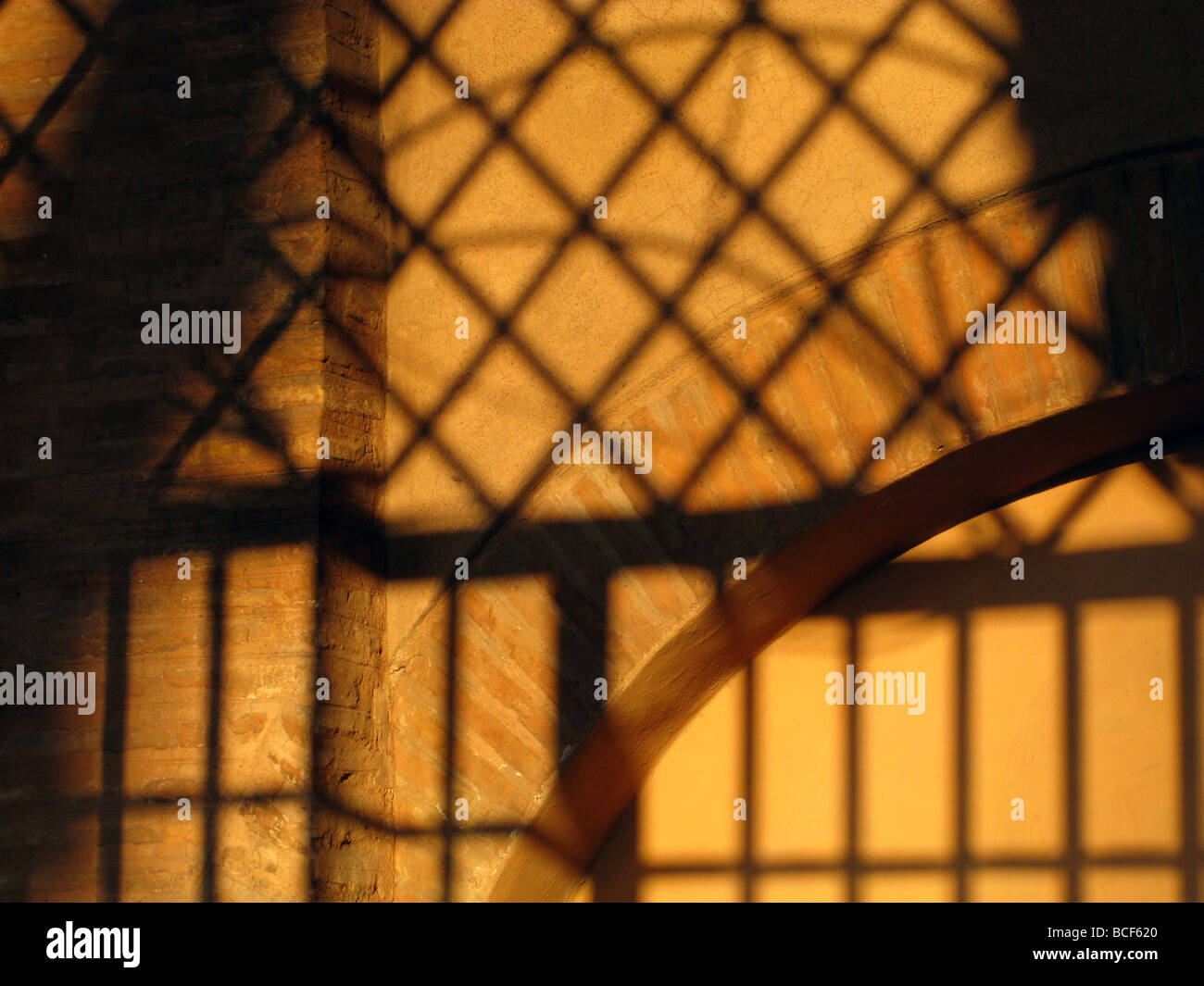 metal bars grill shadow detail on church wall in rome italy Stock Photo