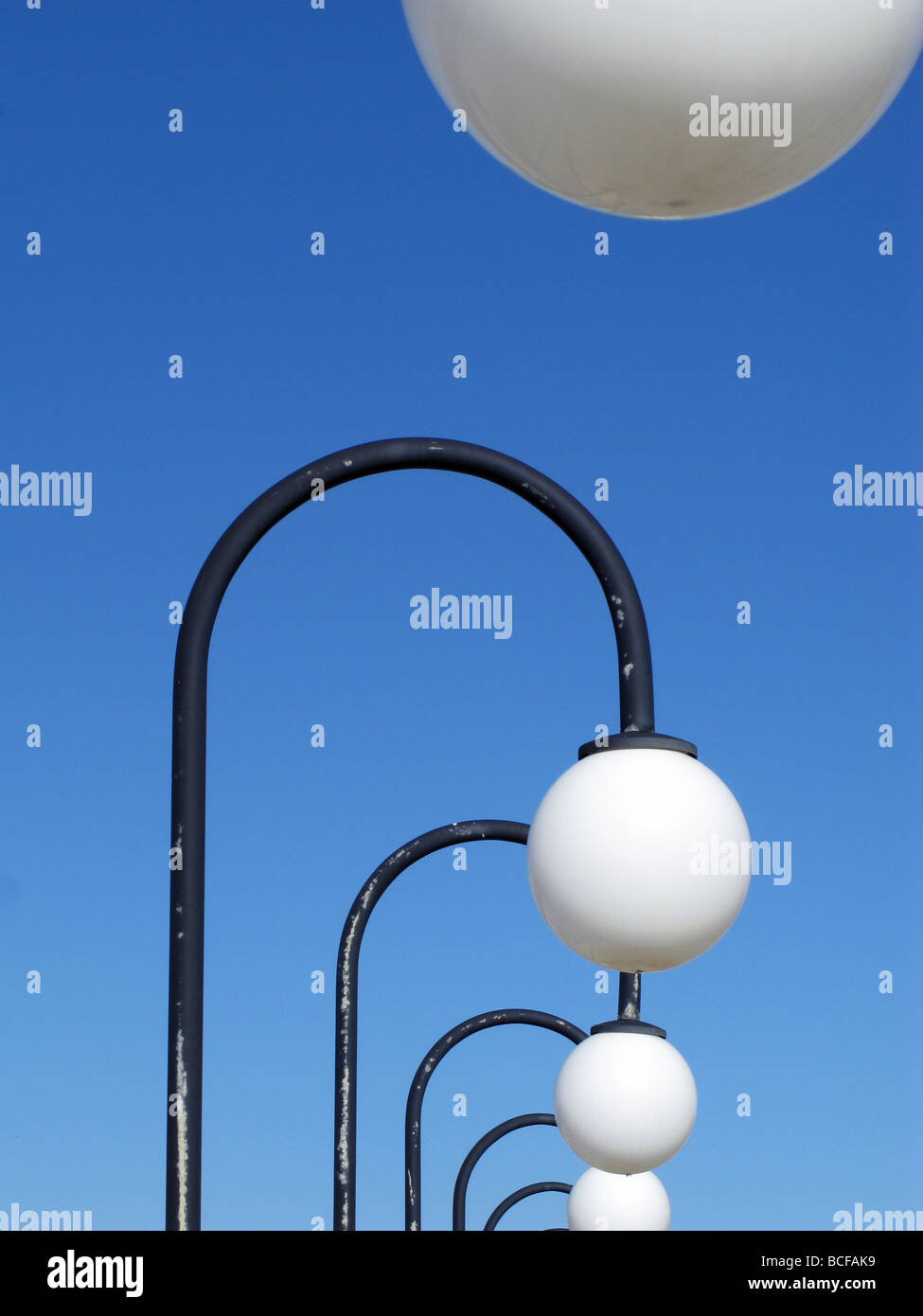 a long row line of street lights and blue sky Stock Photo Alamy