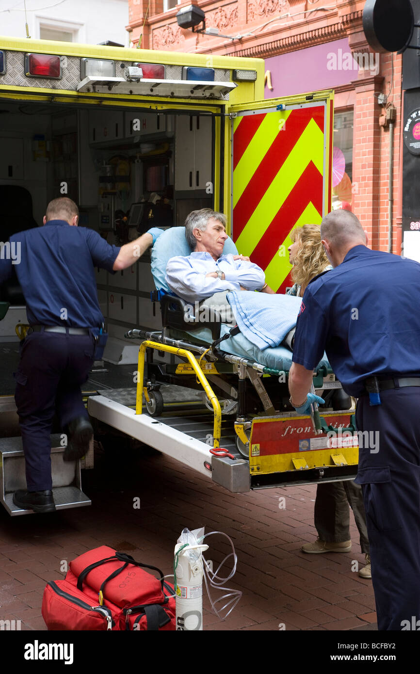 accident victim being loaded into ambulance Stock Photo
