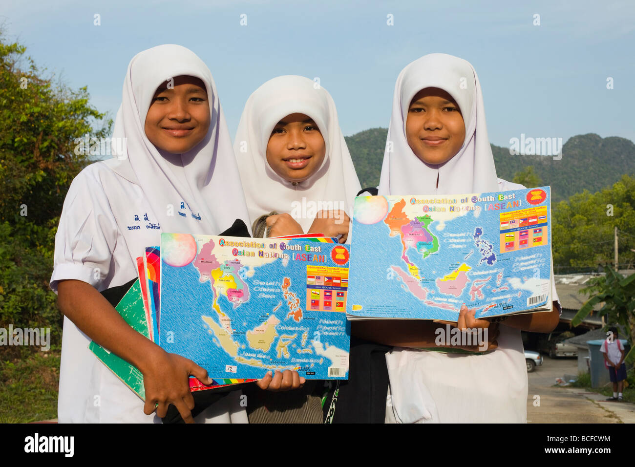 Thailand, Phuket, Krabi, Muslim School Girls Holding ASEAN Region Maps Stock Photo
