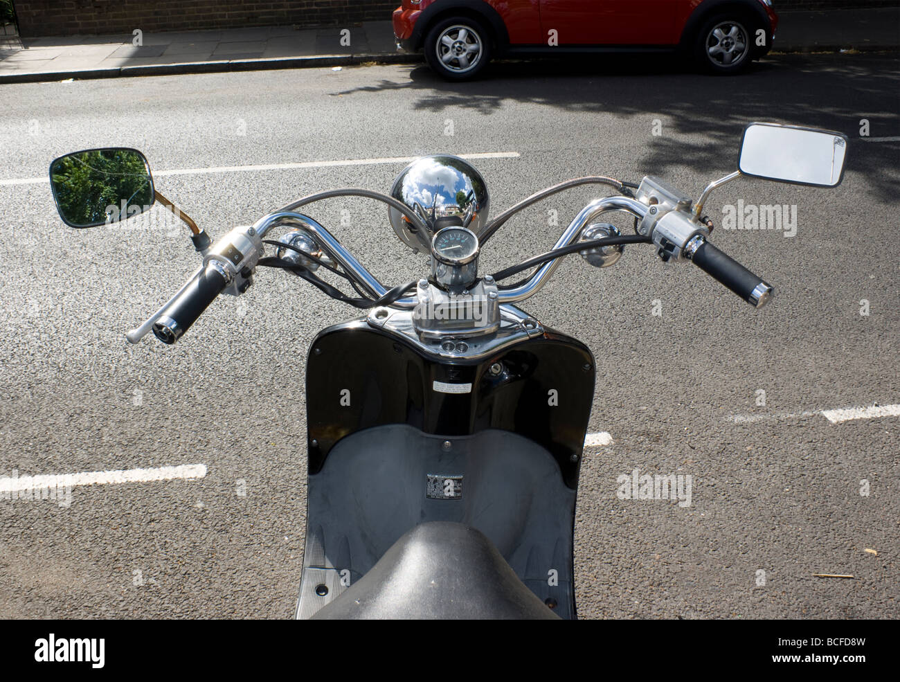 View of handlebars and retro headlight design of a Honda Shadow Scooter  seen on a residential LOndon street in summer Stock Photo - Alamy