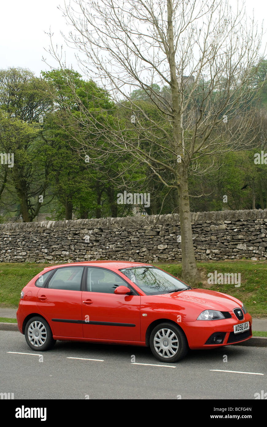 Red seat ibiza car parked at the side of the road in rural Derbyshire England Stock Photo